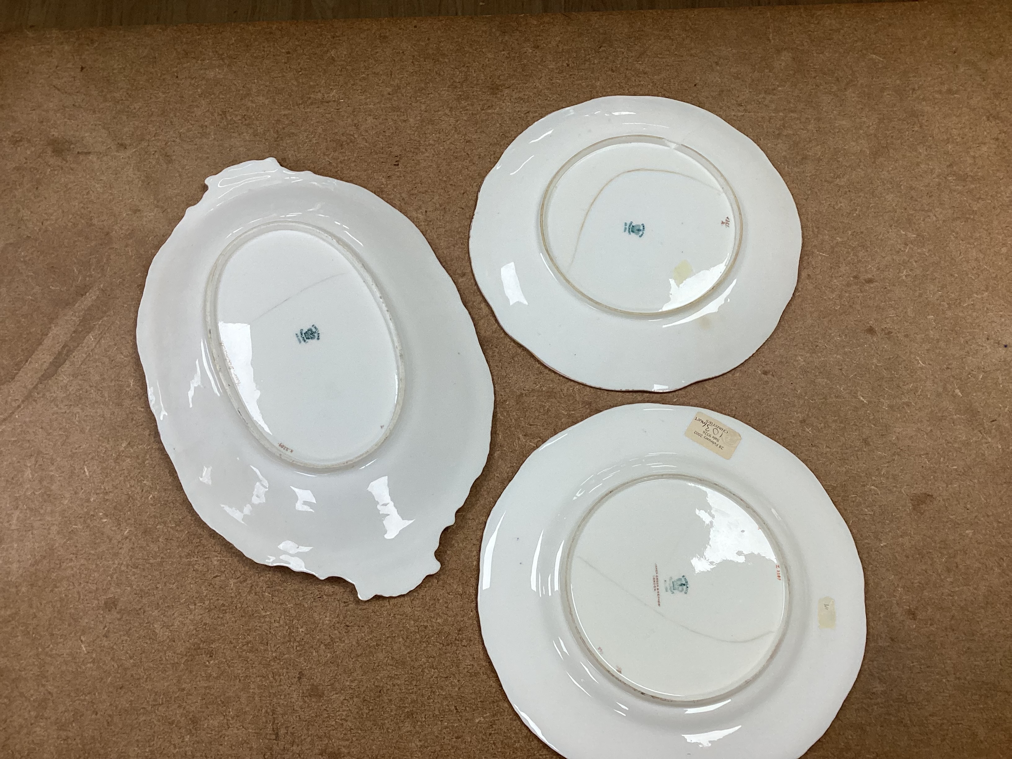 Four 19th century Coalport plates, a Coalport dish, a Minton plate, a Coalport inkstand in Chelsea style and a Derby cache pot, ink stand 40cms wide